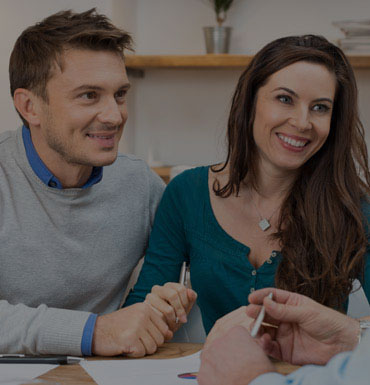 couple talking to financial advisor and making annual budget plan